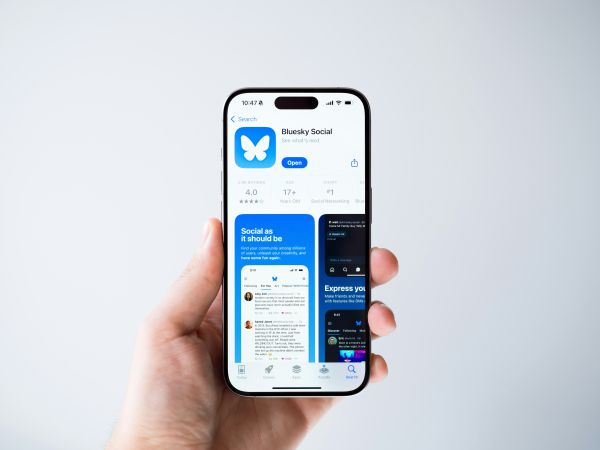 Social media user holding Bluesky app