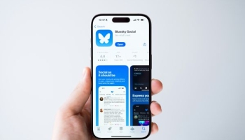 Social media user holding Bluesky app