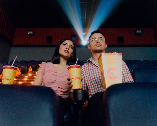 A couple watching a movie at a theater